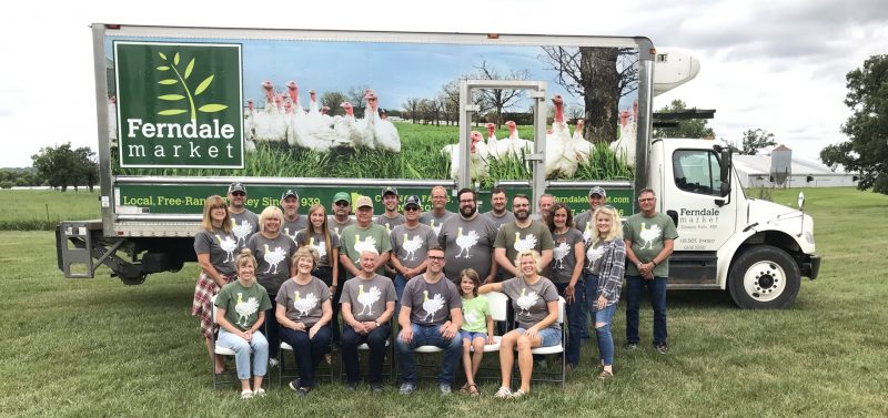 family and staff at Ferndale Market farm sitting in front of their branded trailer