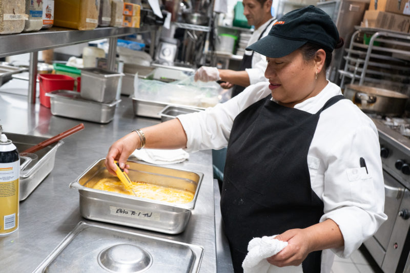 A person working with food in a kitchen