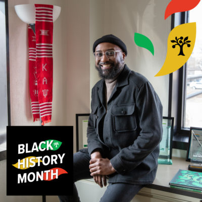 A photo of Ray Williams sitting on a filing cabinet in his office with text overlay reading "Black History Month"