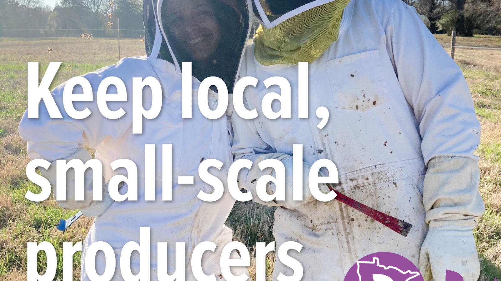 Two people in beekeeping suits posing for a photo with text overlay reading "Keep local, small-scale producers thriving"