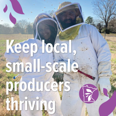 Two people in beekeeping suits posing for a photo with text overlay reading "Keep local, small-scale producers thriving"