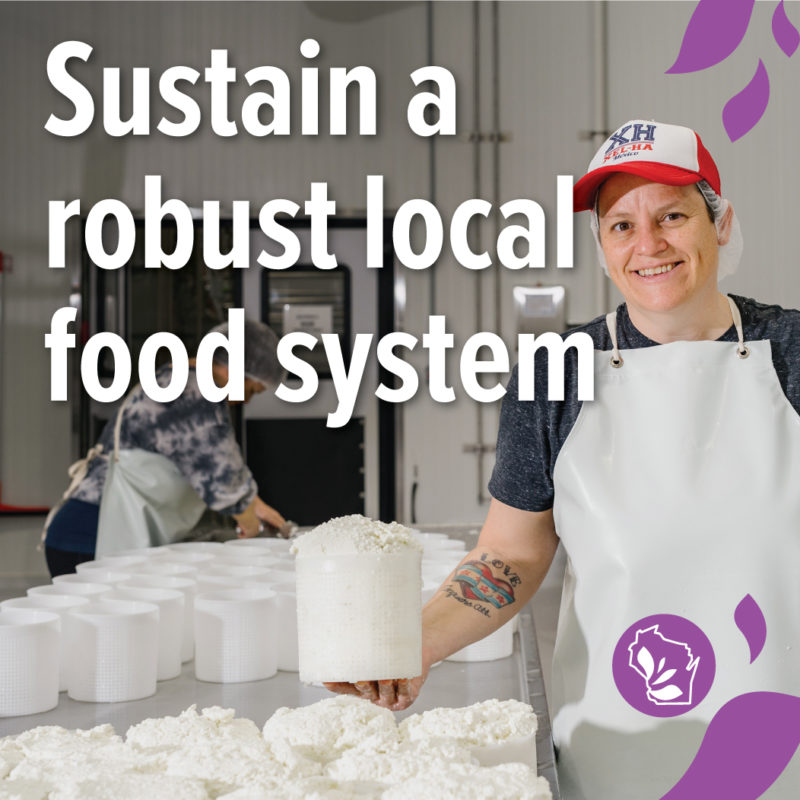 A picture of a person holding cheese and smiling in a creamery with text overlay that reads "Sustain a robust local food system"