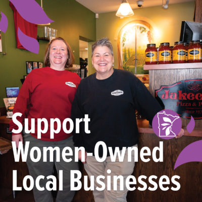 Two women standing next to a sign reading "Jakeeno's" with text overlay that reads "Support Women-Owned Businesses"