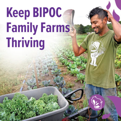 A farmer smiling next to a wheelbarrow of greens with text overlay that reads "Keep BIPOC Family Farms Thriving"