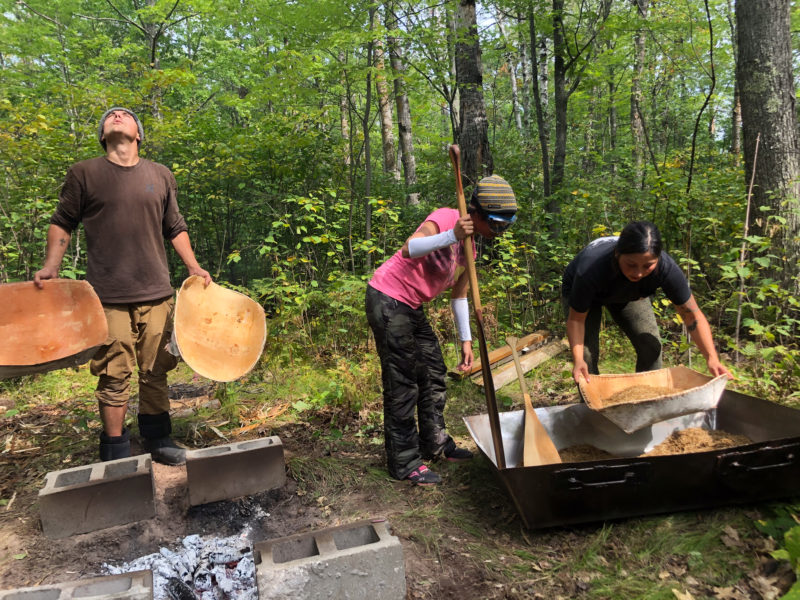A group of people working on a project in the woods
