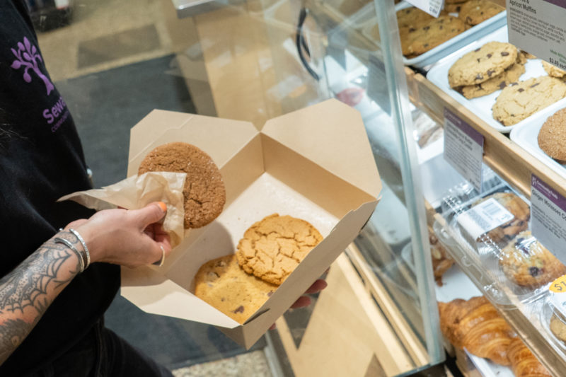 a person putting cookies into a box