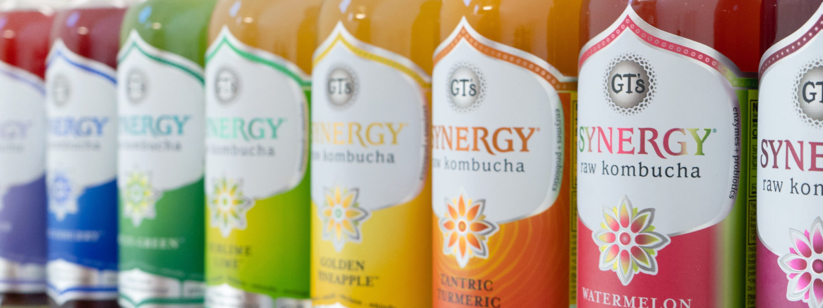 A row of rainbow colored drinks from GT's Kombucha