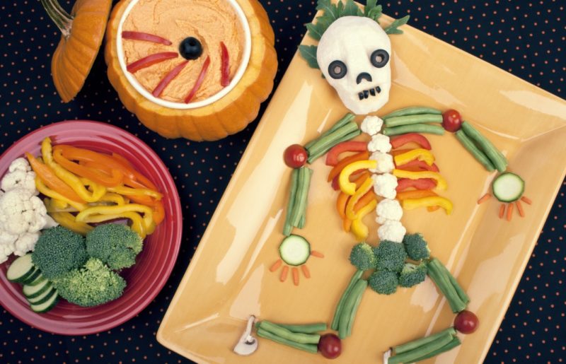 A kid's lunch made of vegetables in the shape of a skeleton
