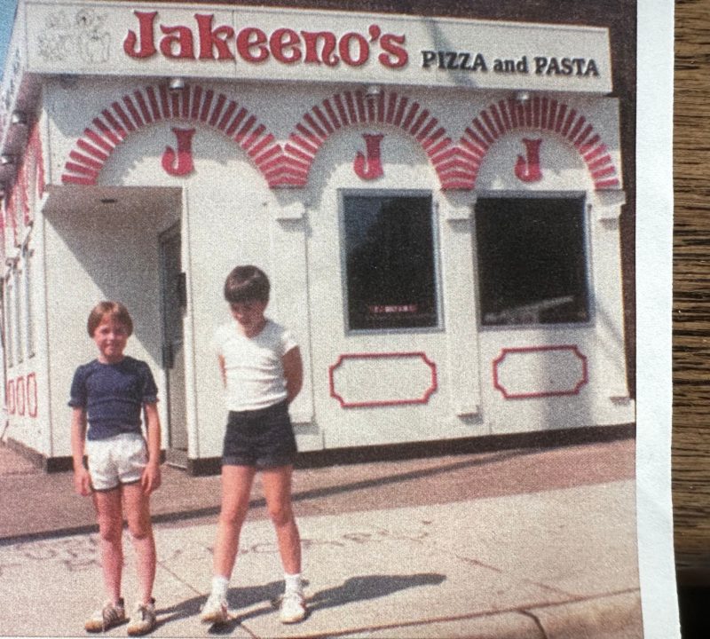 An old photograph of two girls standing in front of Jakeeno's