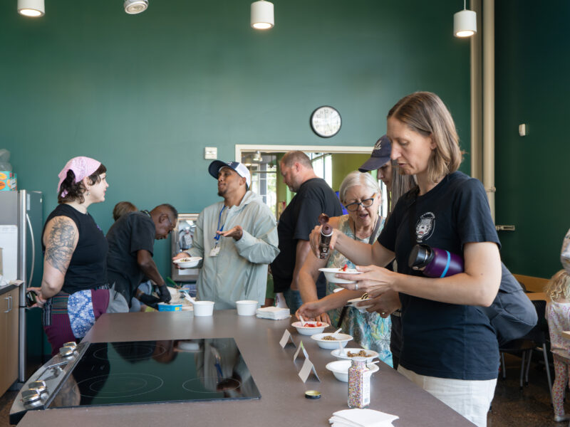 a line of people getting ice cream in the Friendship classroom