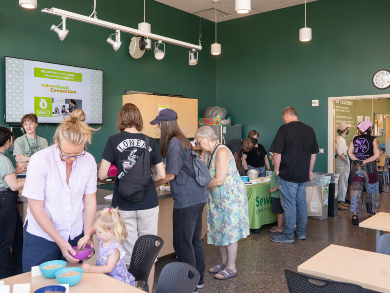 a line of people getting ice cream in the Friendship classroom