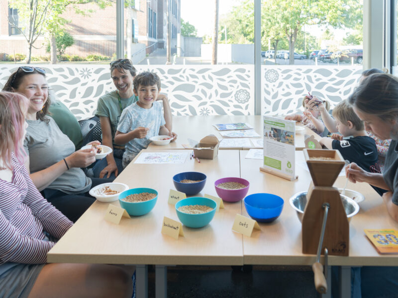 adults and children at a table smiling