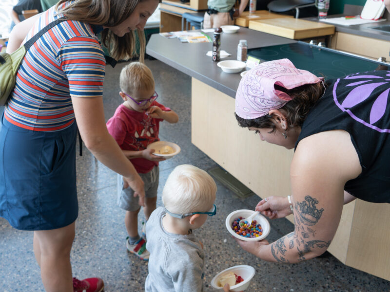 kids with parent looking at ice cream