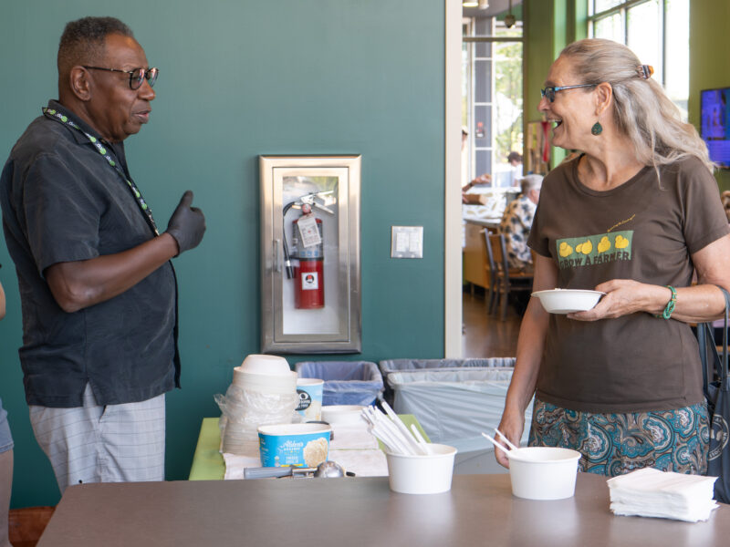 board member talking to shopper