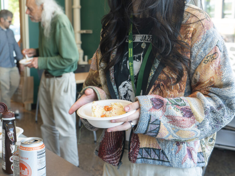 staff member smiling and holding a bowl of ice cream