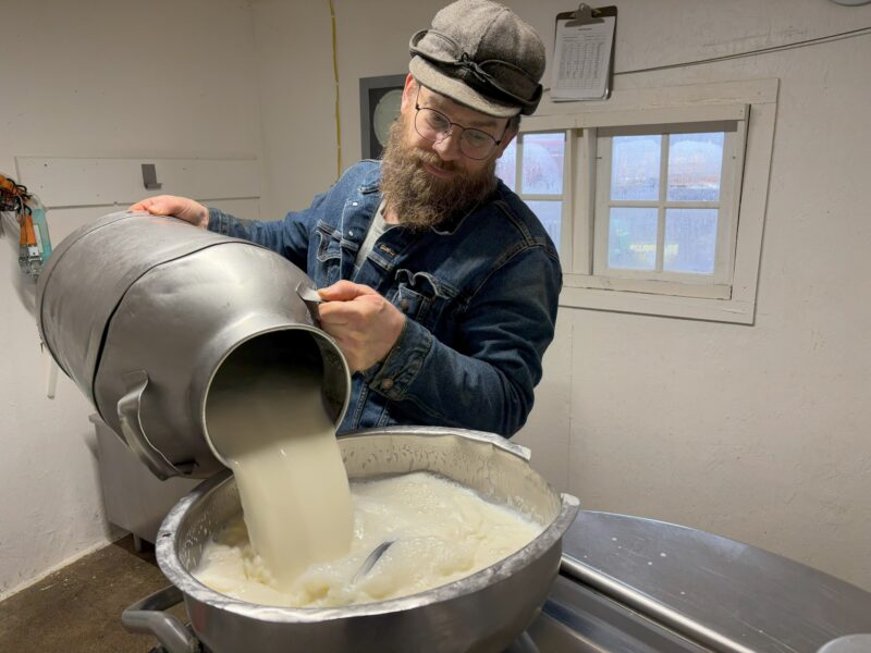 A person making cheese