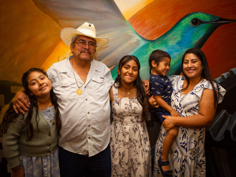 Five people standing together for a family photo