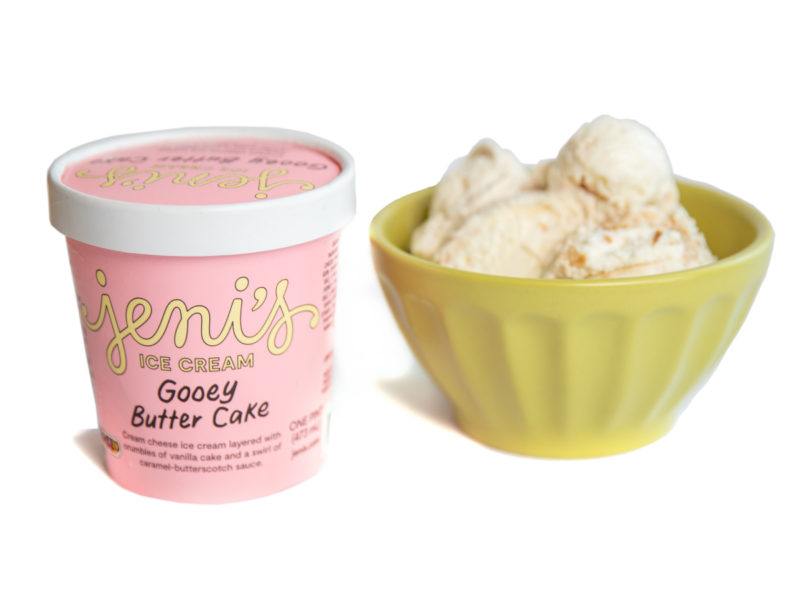 A carton and bowl of Jeni's Gooey Butter Cake ice cream 