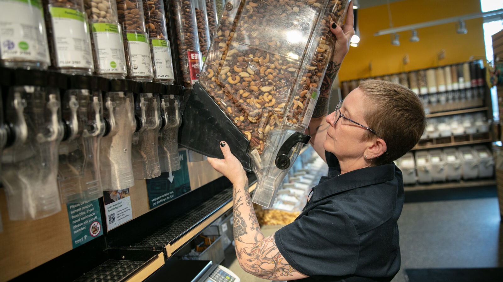 A person stocking containers in the Bulk aisles of Seward Co-op