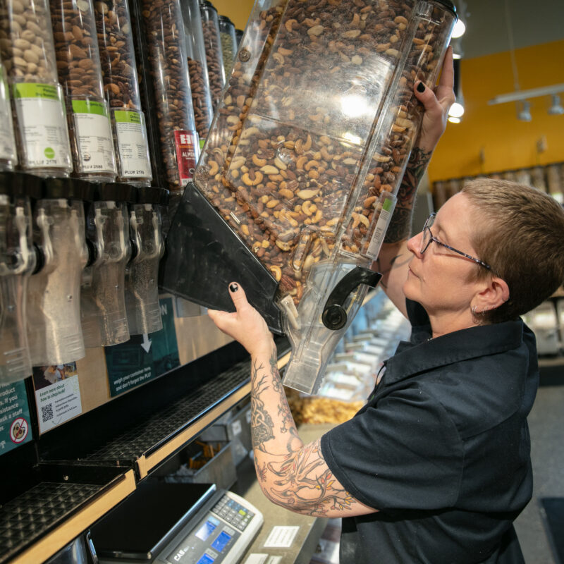 A person stocking containers in the Bulk aisles of Seward Co-op