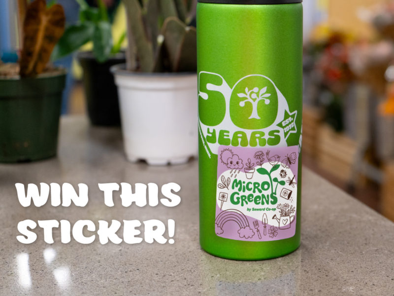 A water bottle with a Microgreens sticker that reads "Win this Sticker!"
