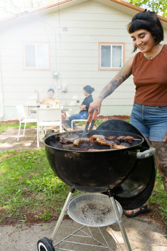 A person grilling in their backyard