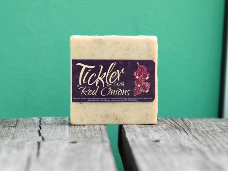 A photo of the Tickler Red Onion Cheddar on a green background