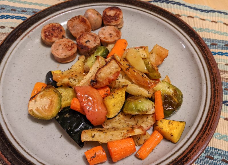 roasted root vegetables and apples with sliced sausage