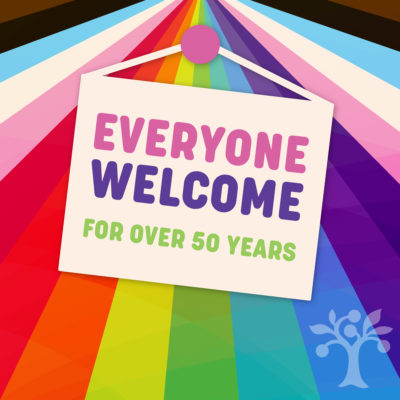 A rainbow with a sign overlay that reads "Everyone Welcome for Over 50 Years"