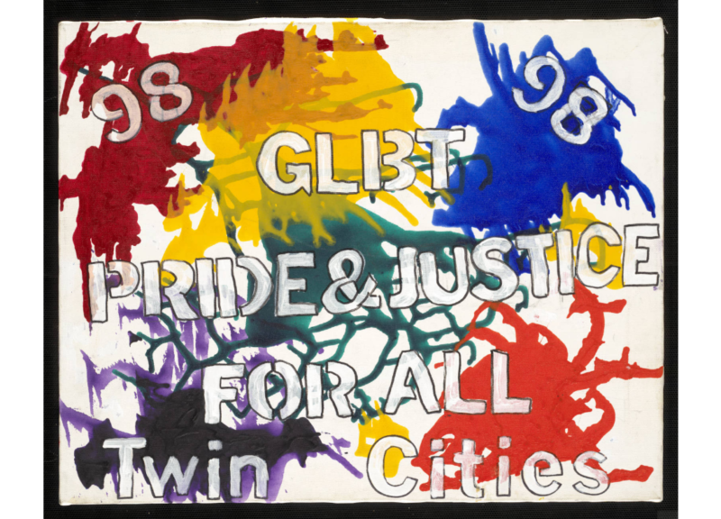 A poster with rainbow paint splashes and text reading "GLBT Pride & Justice for All, Twin Cities, '98"