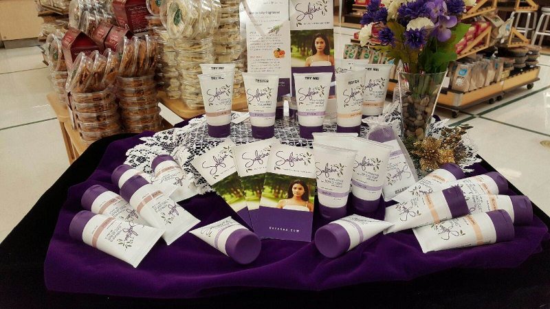 A table with a purple tablecloth and bottles of Safesha hand santizer
