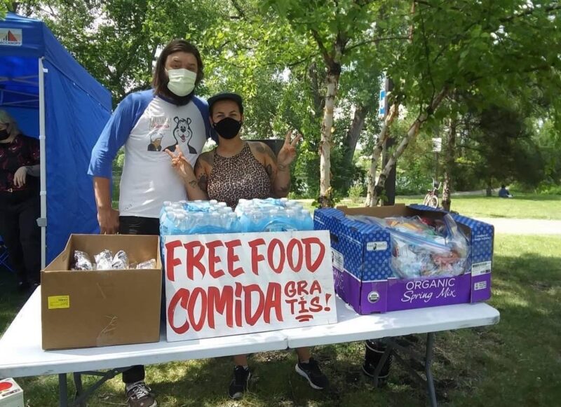 People at a table handing out free food