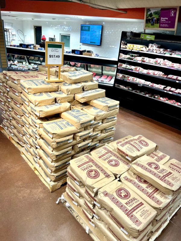 Large bags of teff stacked in the Franklin store