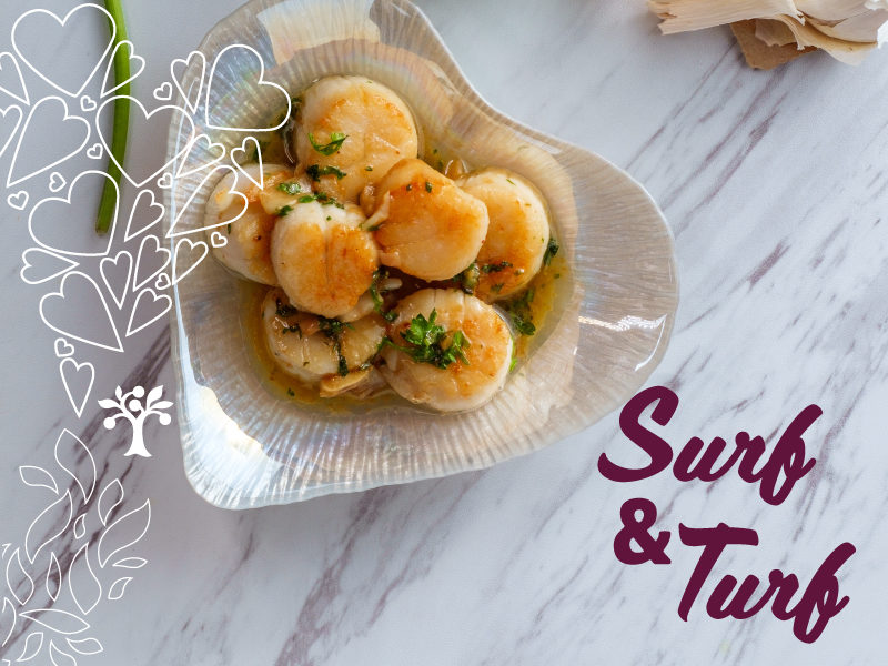 A heart shaped dish full of scallops with text that reads "Surf and Turf"