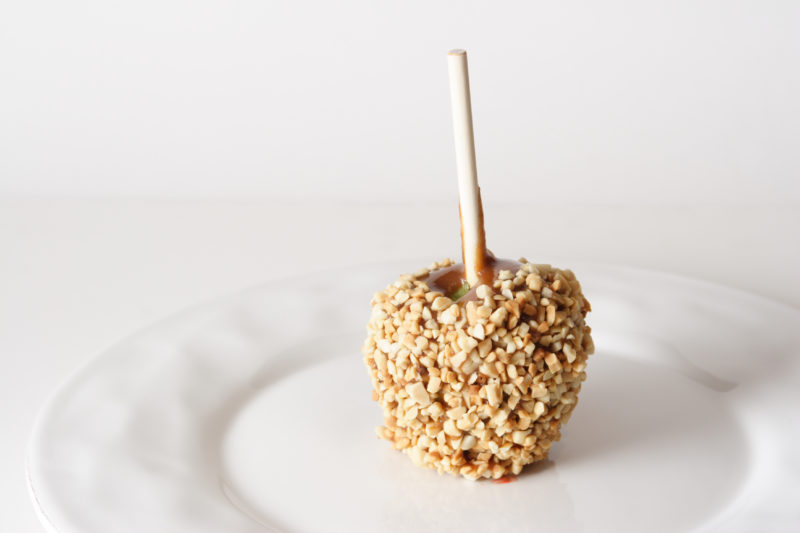 A candy apple with nuts
