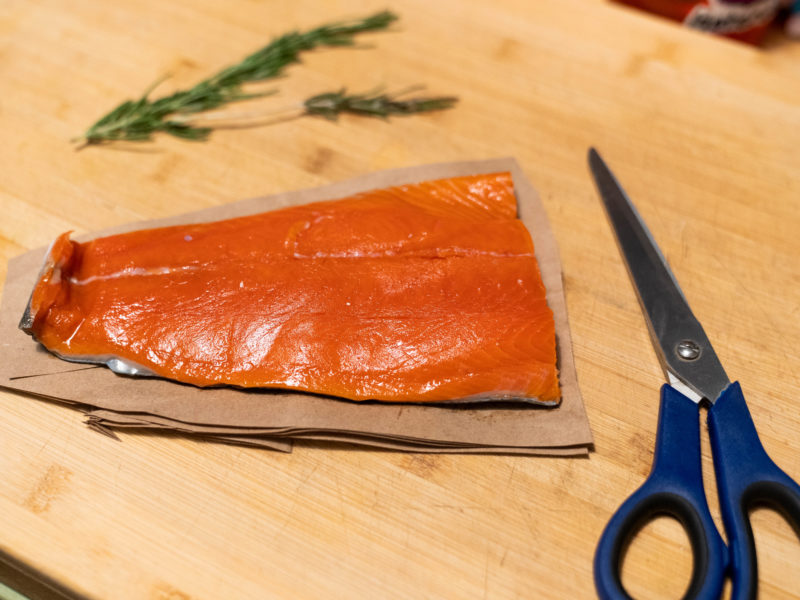 A filet of salmon on a brown piece of paper