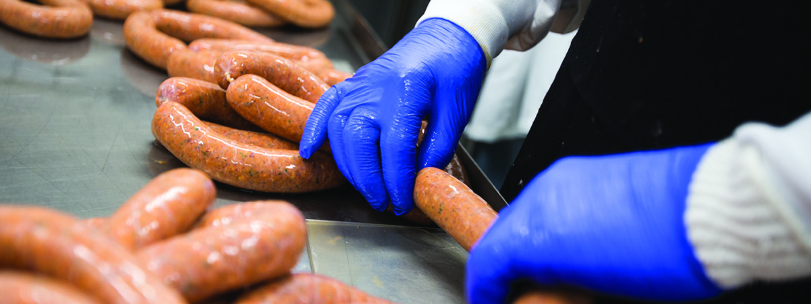 A person's hands making sausage