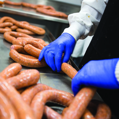 A person's hands making sausage