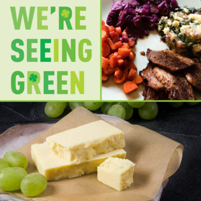 A photo of the St. Patrick's Day hot bar offerings, cheddar cheese, and text that reads "We're Seeing Green"